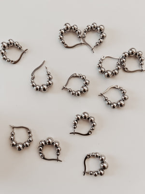 
                  
                    Silver beaded hoops
                  
                