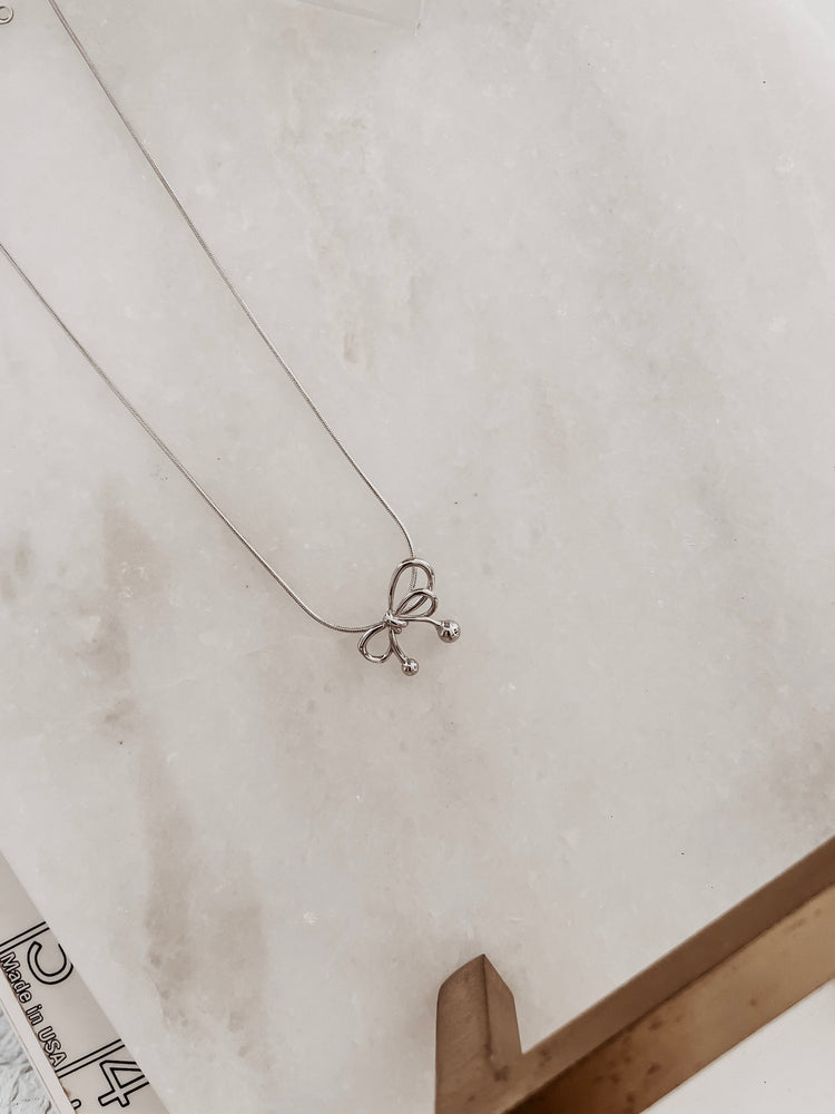 
                  
                    Silver bow necklace
                  
                